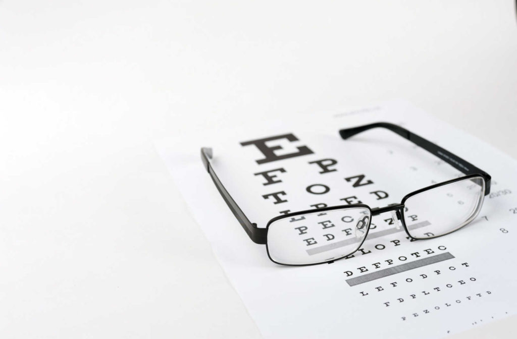 Eyeglasses on the eyesight test chart.