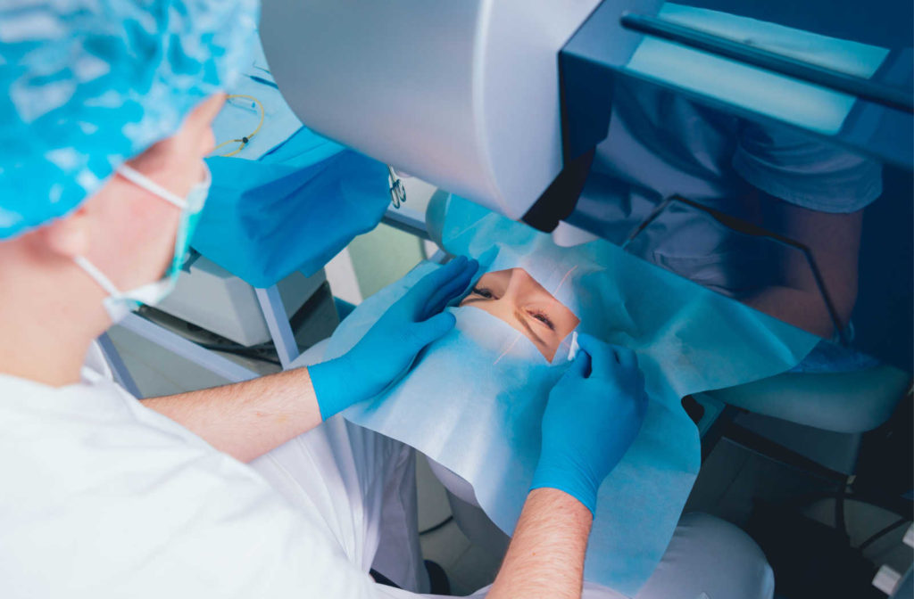 A male surgeon is preparing his patient before eye surgery.