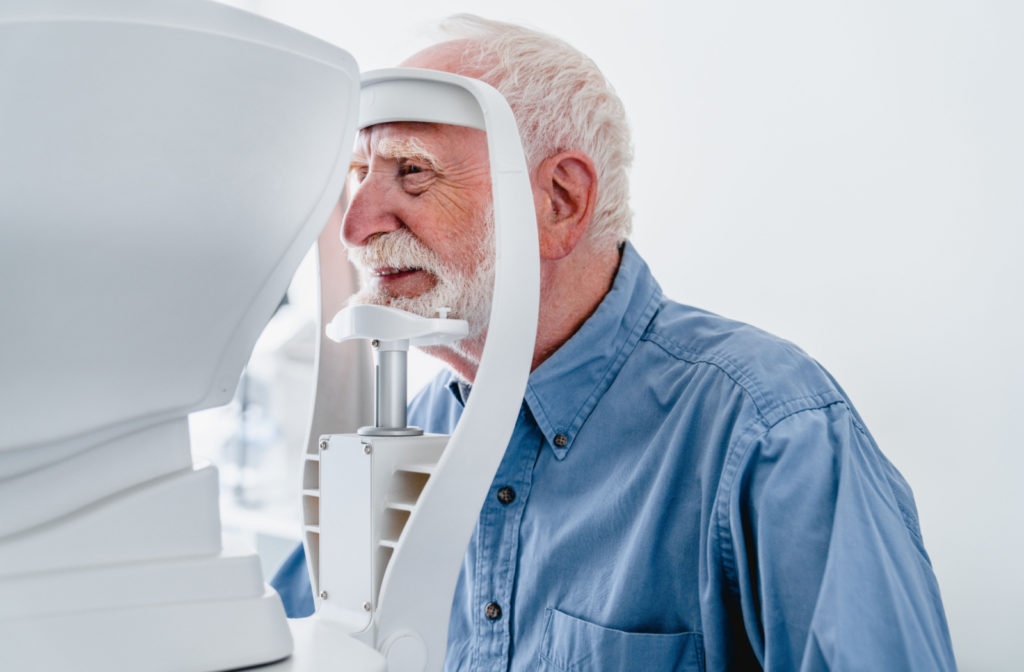 Mature men being examined at a retinal camera.
