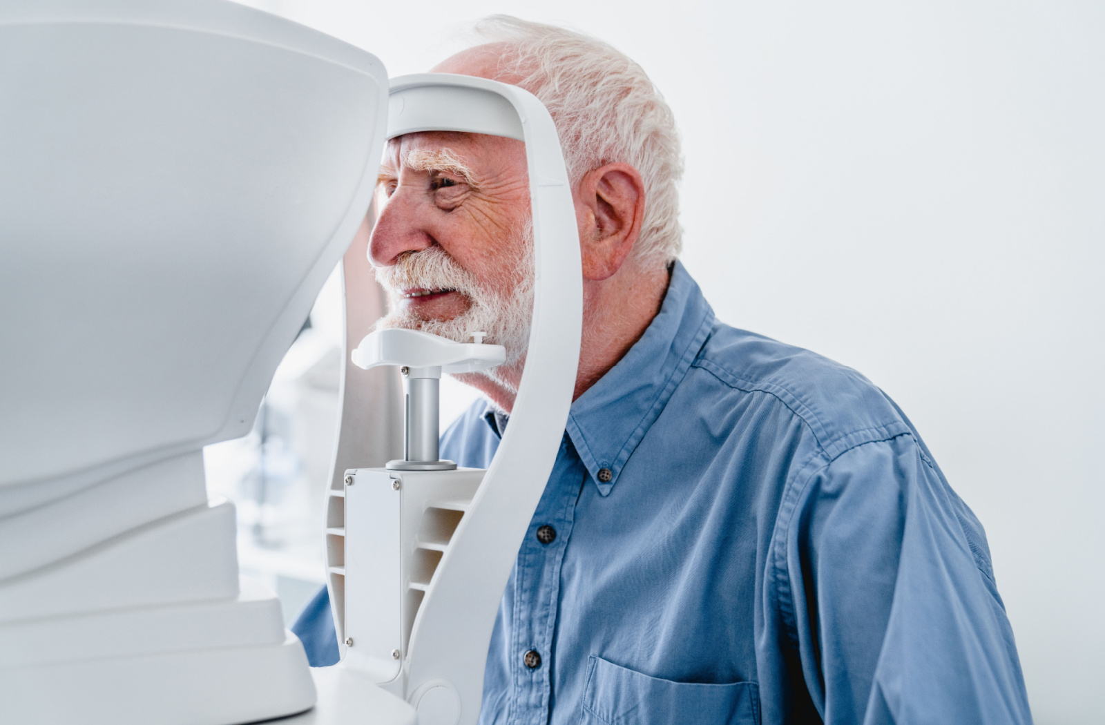 Mature men being examined at a retinal camera.