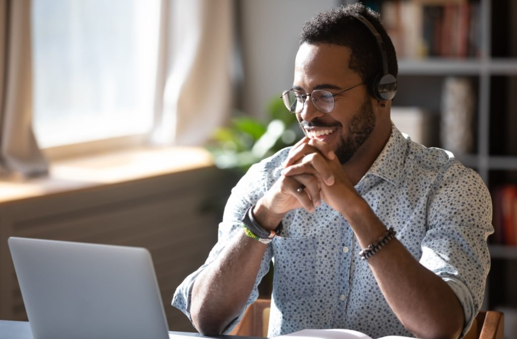 Smiling adult man at a computer.