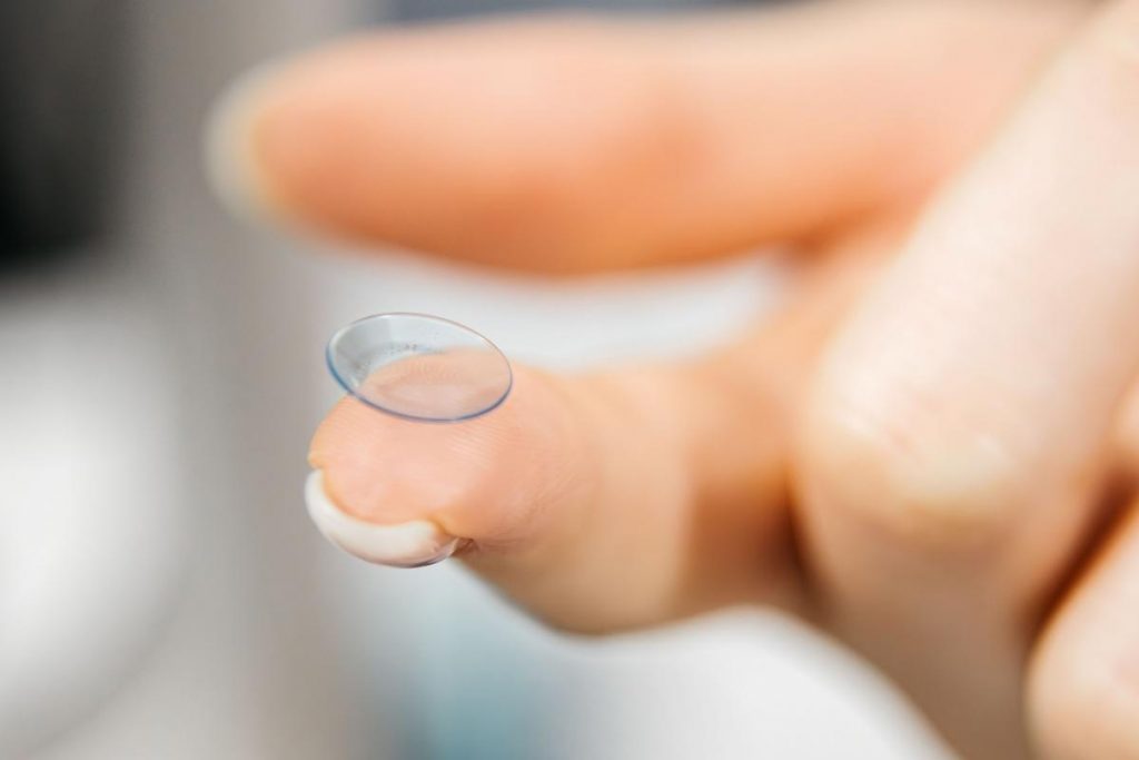 Up close image of contact lens on a finger tip.